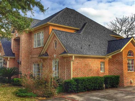 brick on metal house|black shingles on brick house.